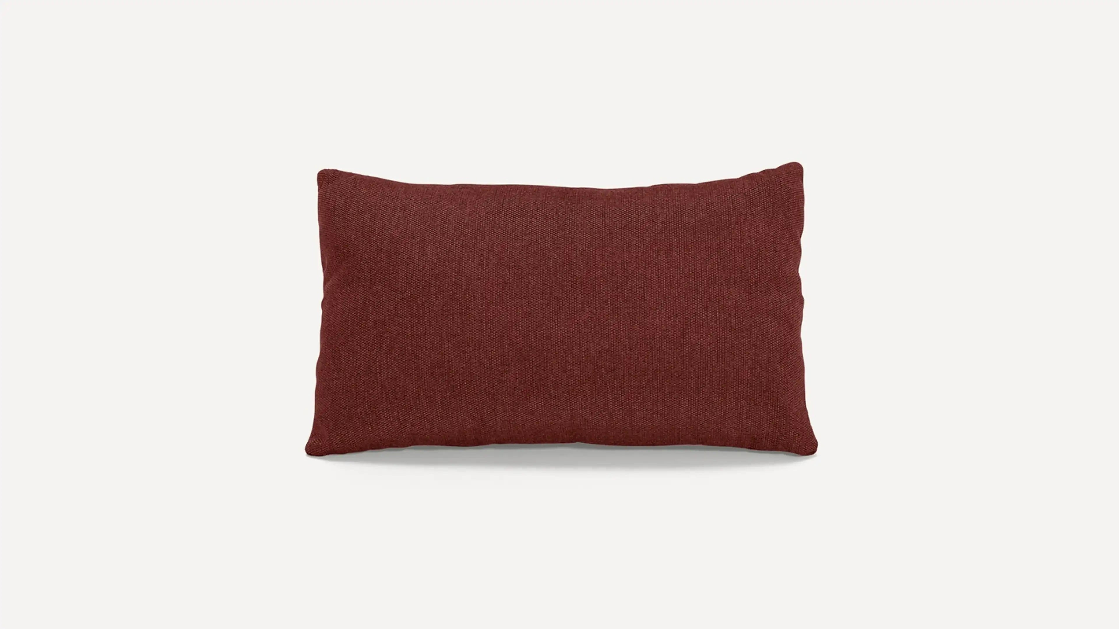a red pillow on a white background