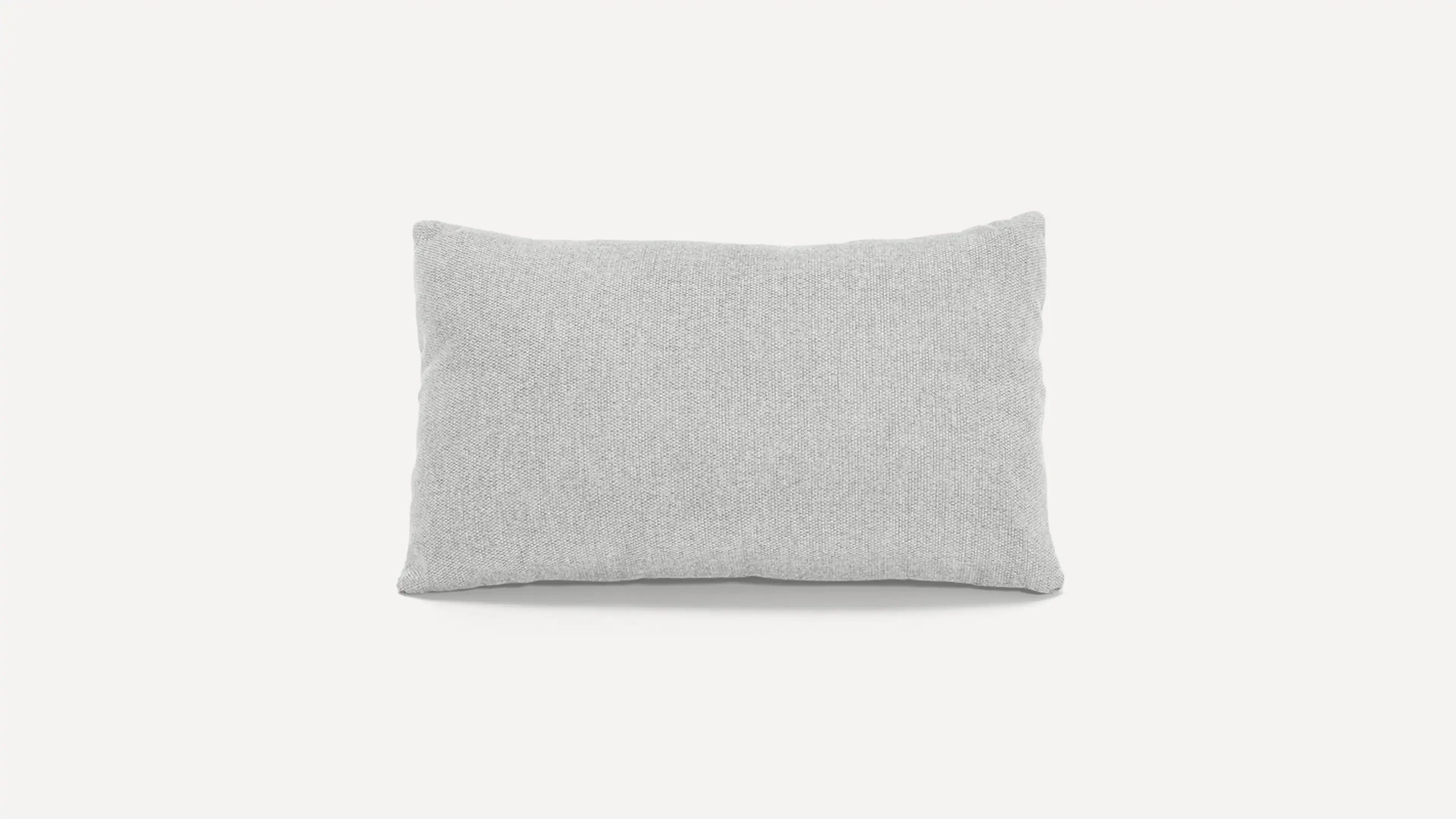 a light gray pillow on a white background