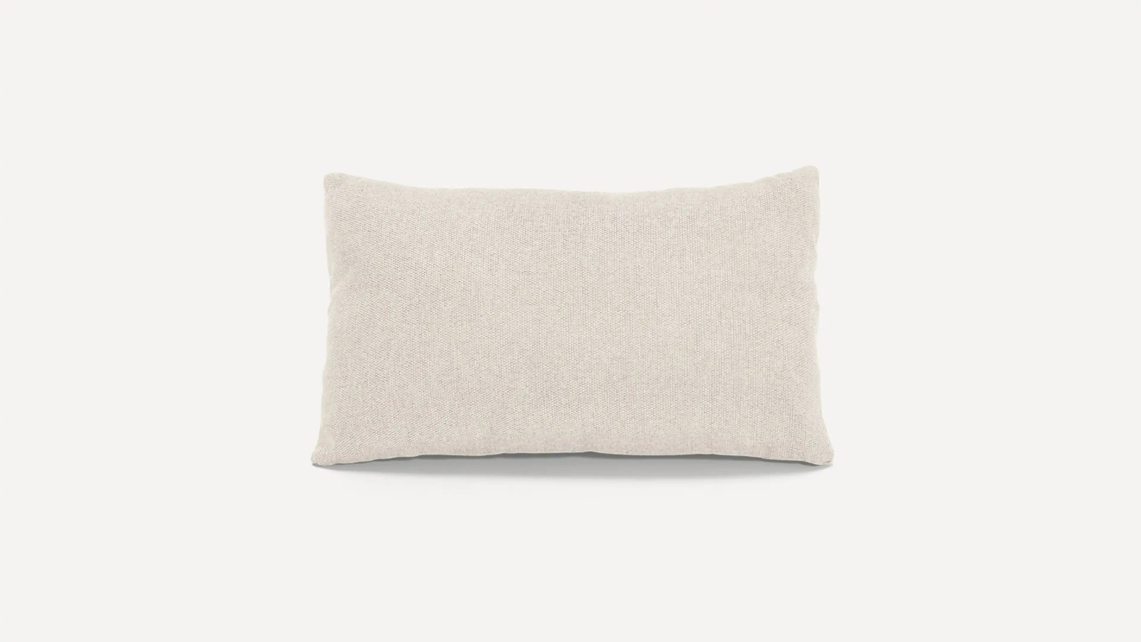 a beige pillow with a white background