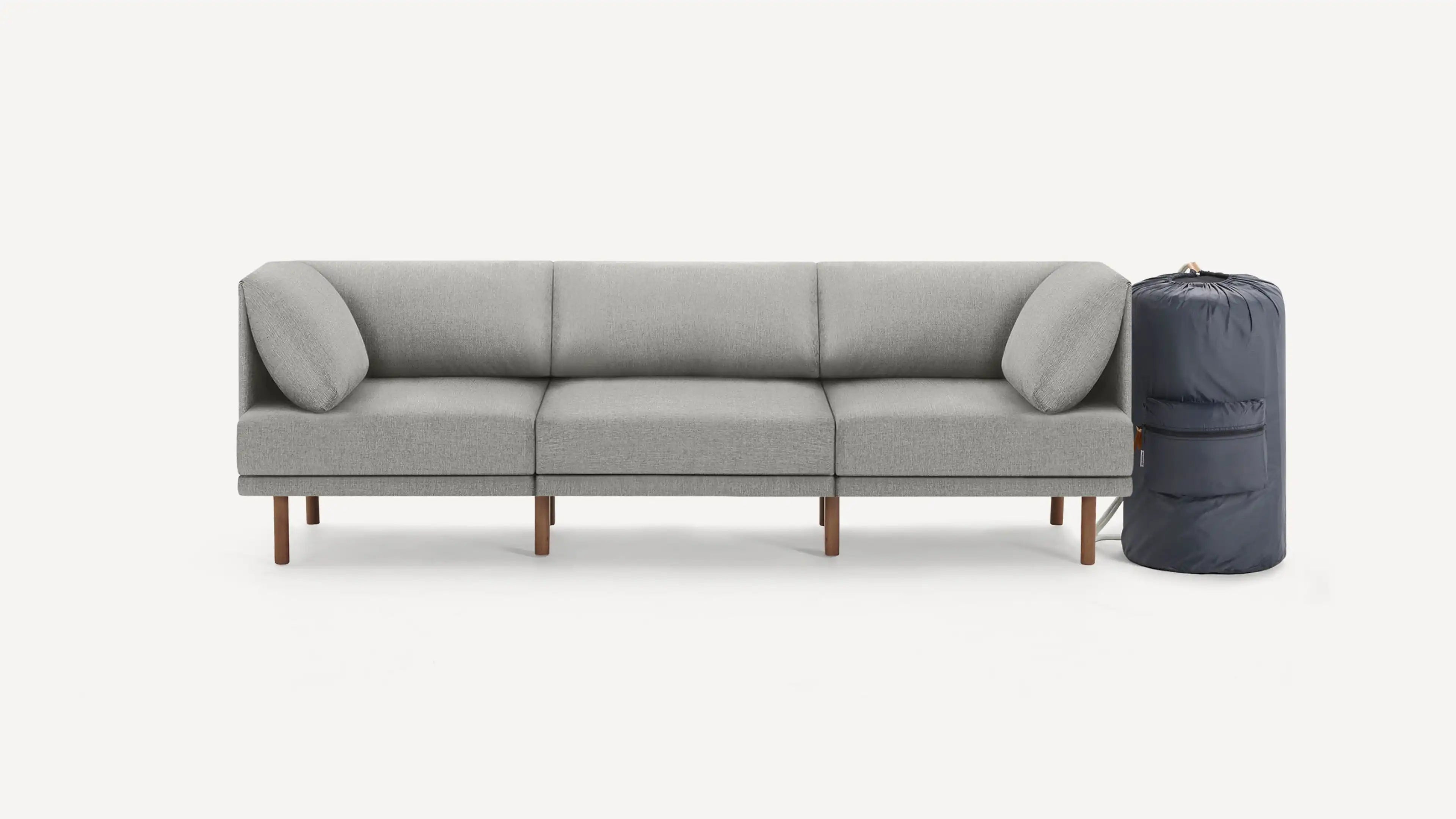 modern light gray fabric sectional sofa with wooden legs, featuring a soft cushioned back, and a matching cushioned back, on a white background