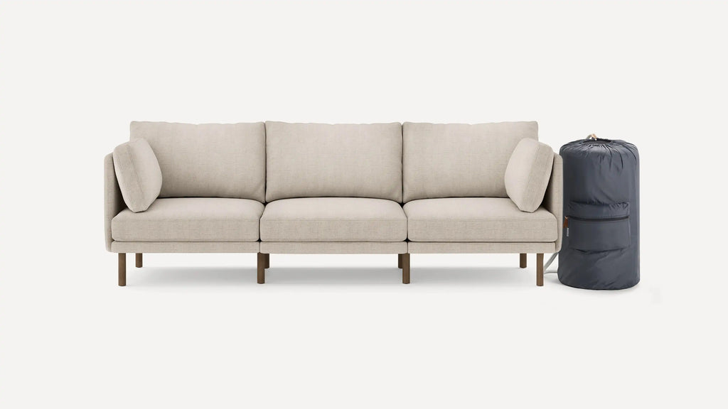 modern beige fabric sectional sofa with wooden legs and clean lines on the back, featuring a soft cushion and clean lines on the back