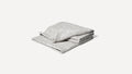 a gray blanket folded on top of a white background