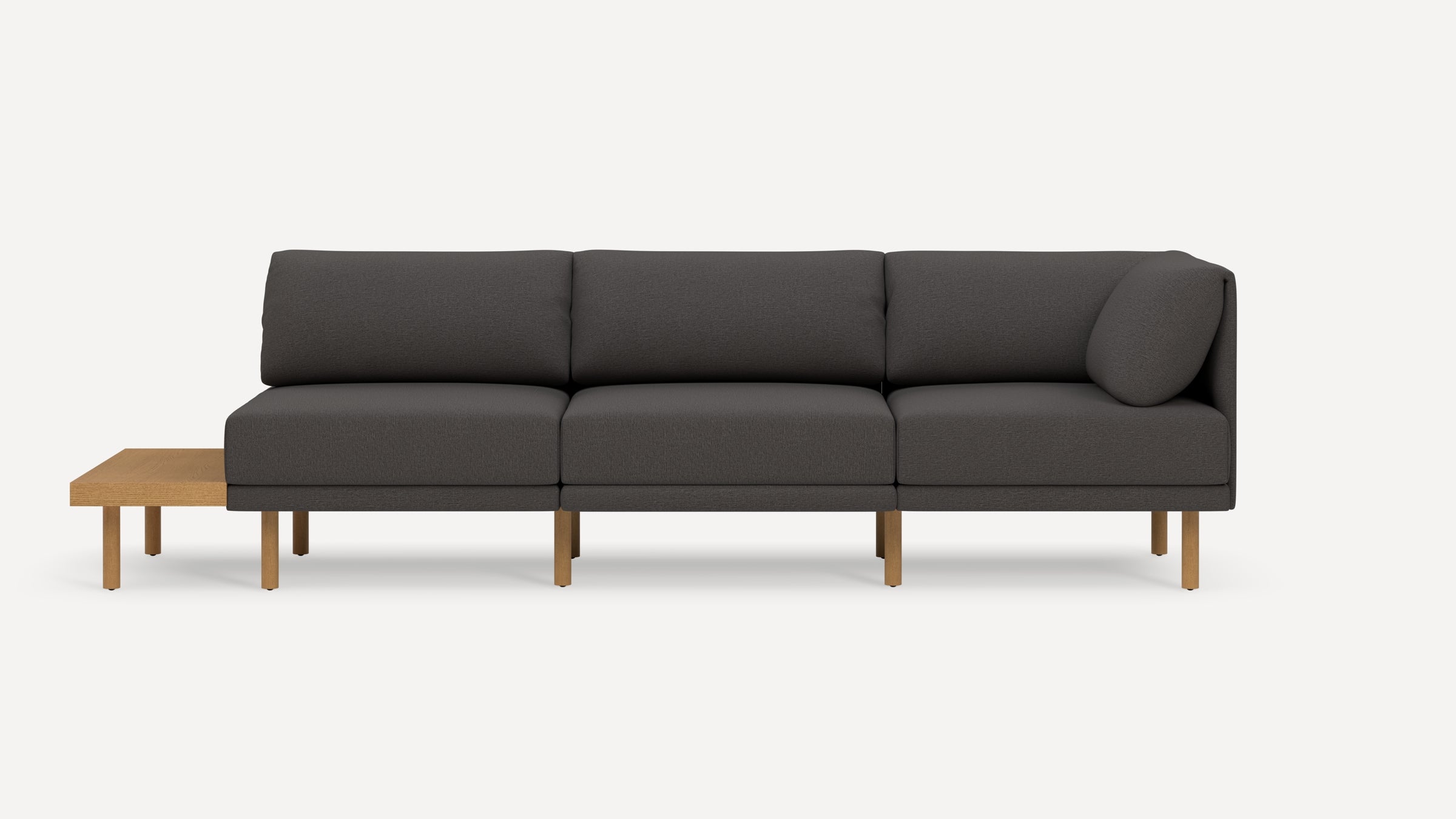 Modern dark gray sectional sofa with wooden legs and attached side table, featuring clean lines and minimalistic design.