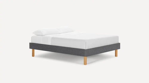 modern upholstered bed with grey fabric upholstered bed frame and light wood legs, featuring a white pillow and white pillow