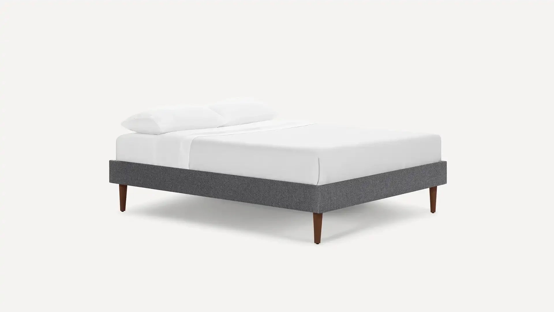 modern upholstered bed with dark gray upholstered bed frame, light gray upholstered bed frame, and white pillows