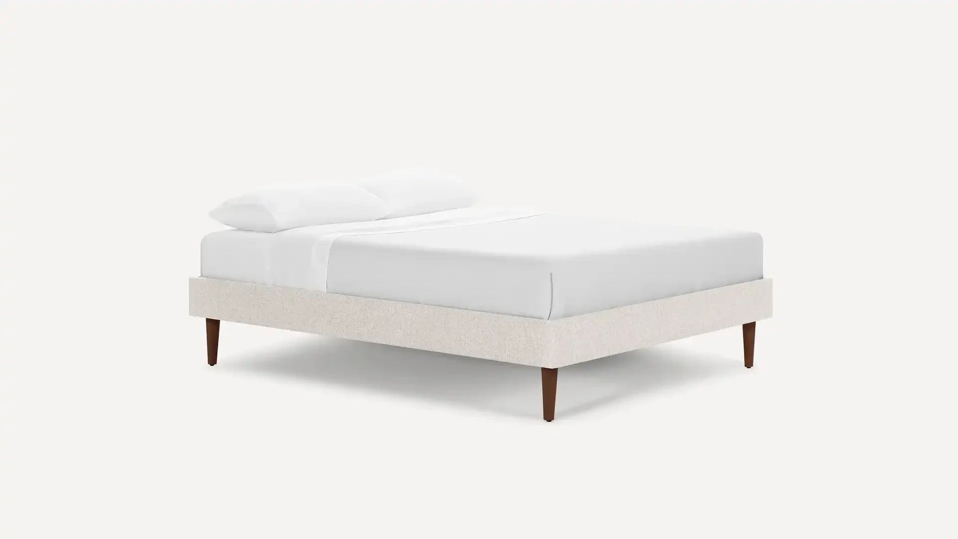 modern upholstered bed with upholstered headboard and white linen upholstered pillow on a white background