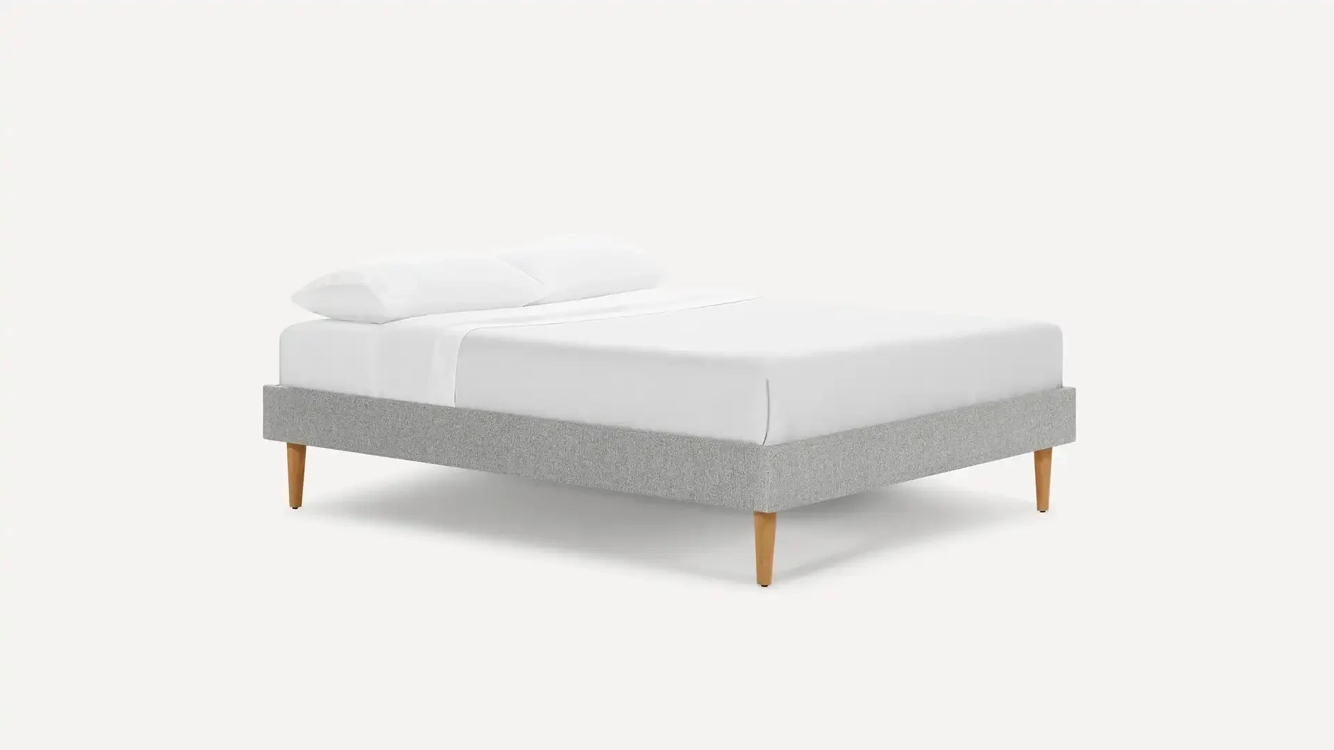modern upholstered bed with light gray upholstered bed frame, light gray upholstered bed frame, and white pillows