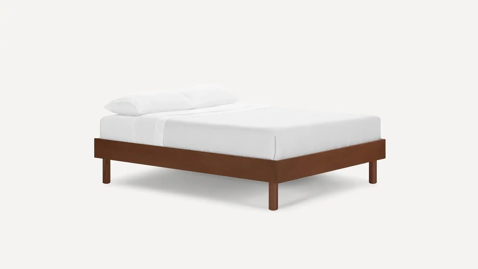 modern bed with wooden frame and white sheets on top