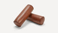 two brown leather tube cases on a white background