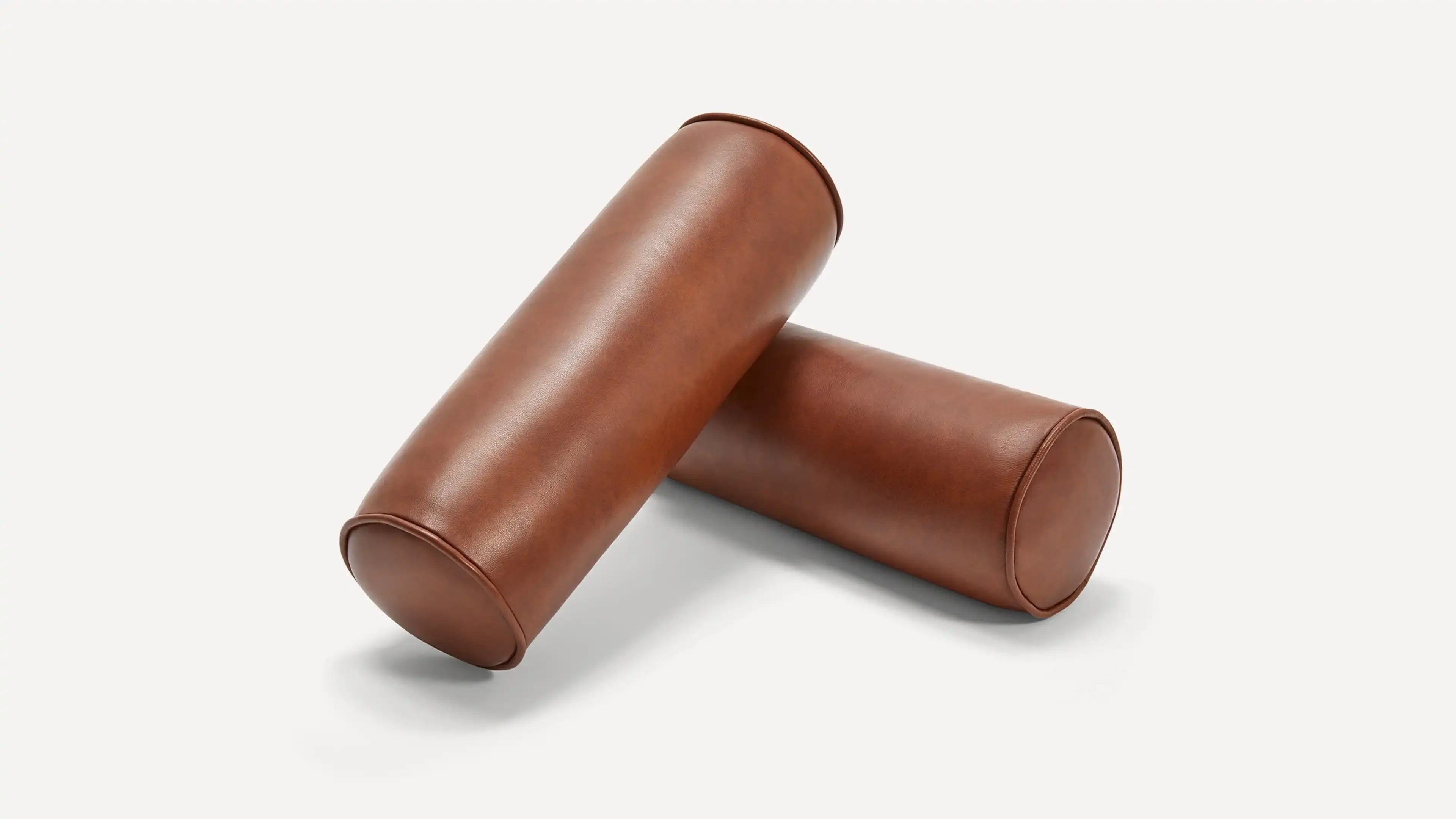 two brown leather tube cases on a white background