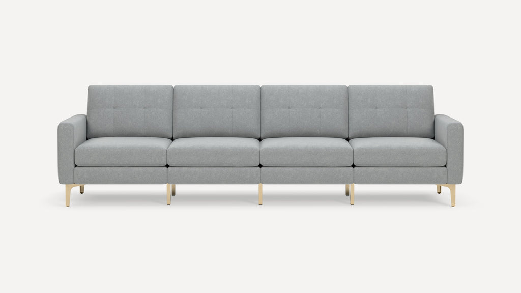 Modern four-seater sofa with light gray tufted upholstery and slim gold metal legs against a plain white background.