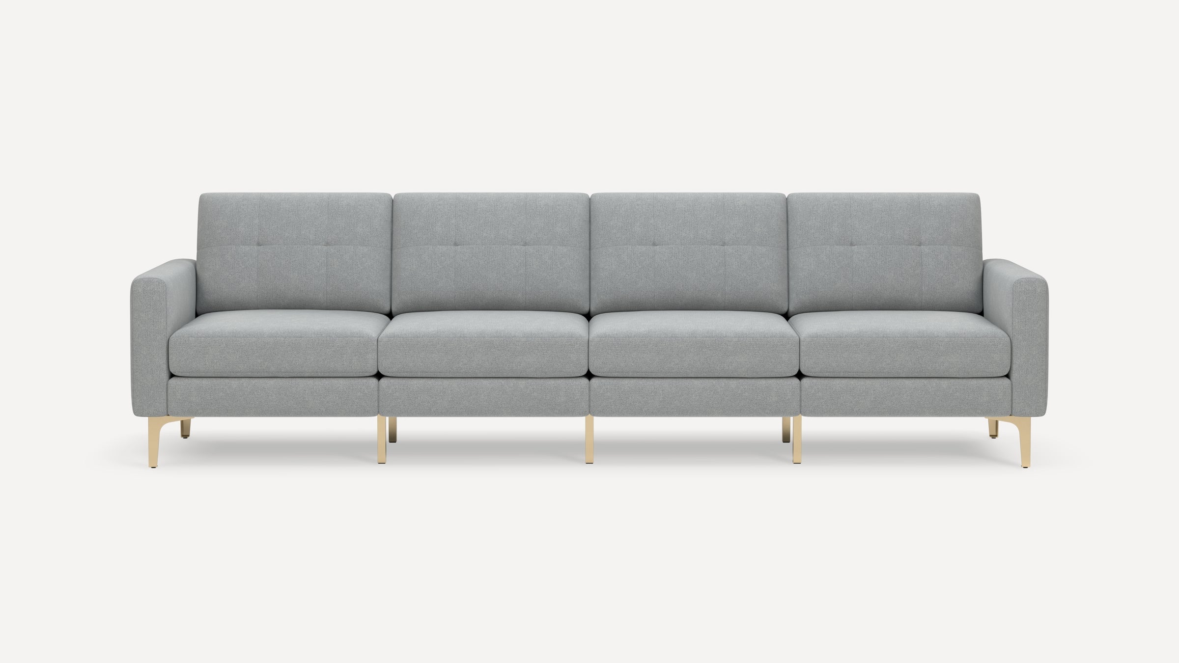 Modern four-seater sofa with light gray tufted upholstery and slim gold metal legs against a plain white background.