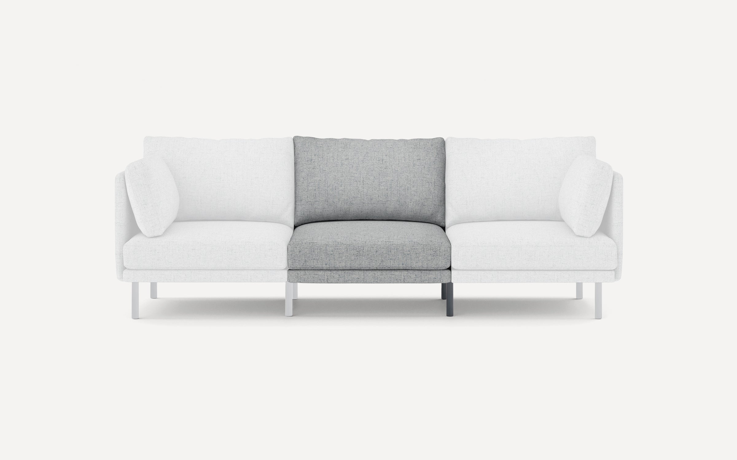 Modern three-seater sofa with white upholstery and a central seat cushion in contrasting light gray fabric, supported by slim legs.