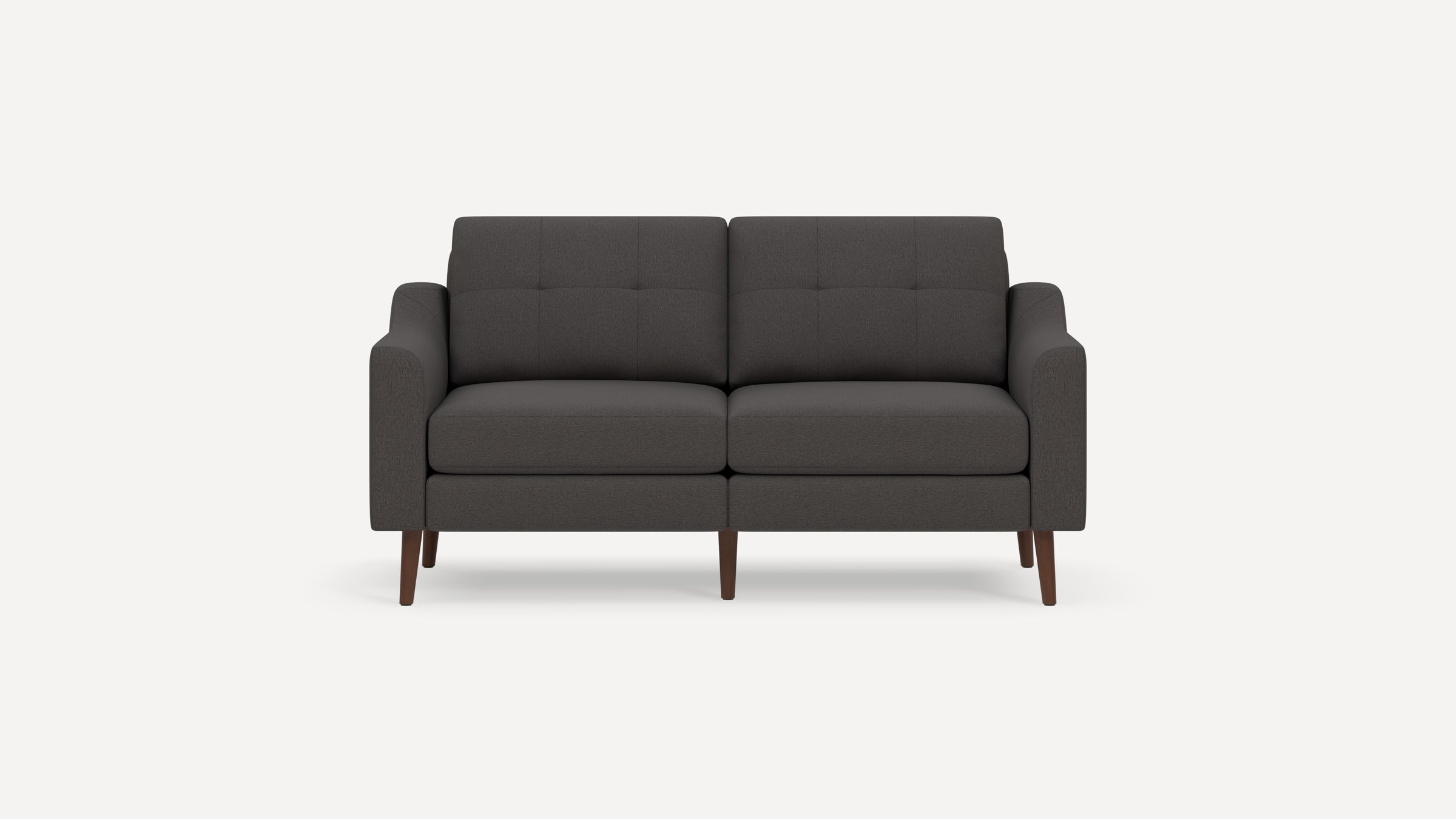 Modern dark gray fabric loveseat sofa with tufted back cushions and wooden tapered legs on a white background.