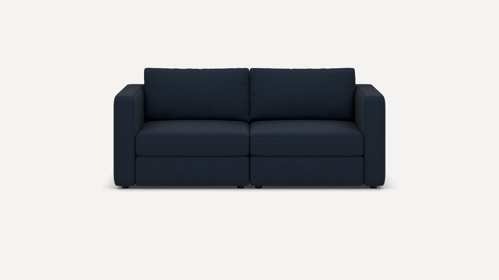 Front view of a modern navy blue two-seater sofa with squared armrests and cushioned backrest on a white background.