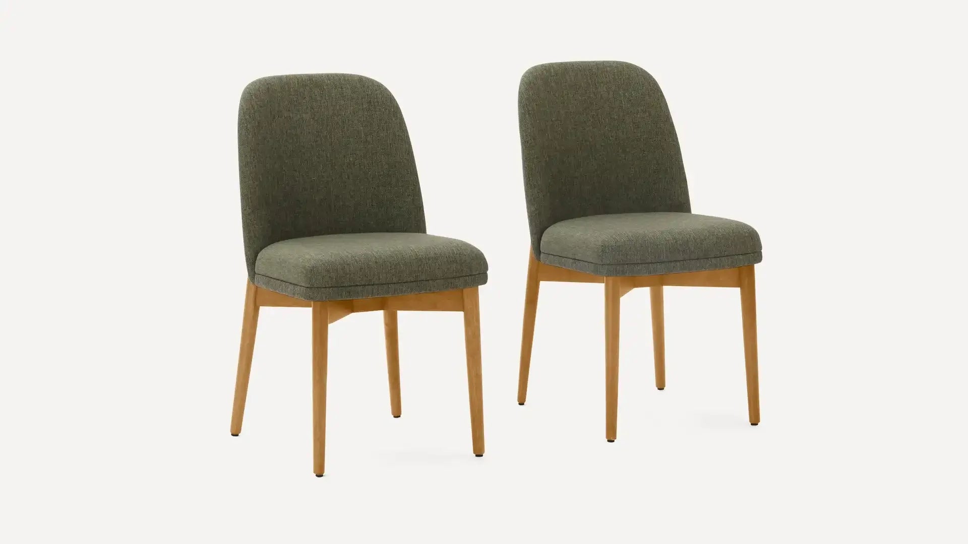 Two olive green upholstered dining chairs with wooden legs on a plain light background.
