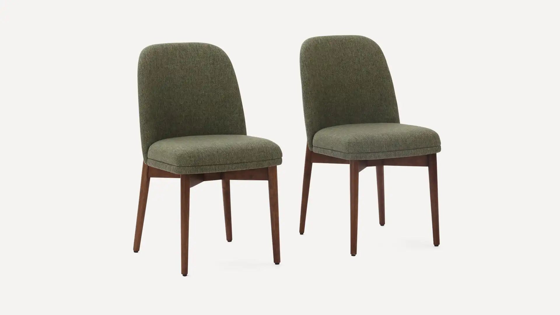 Pair of modern dining chairs with olive green upholstered seats and backs, supported by wooden legs in a walnut finish.