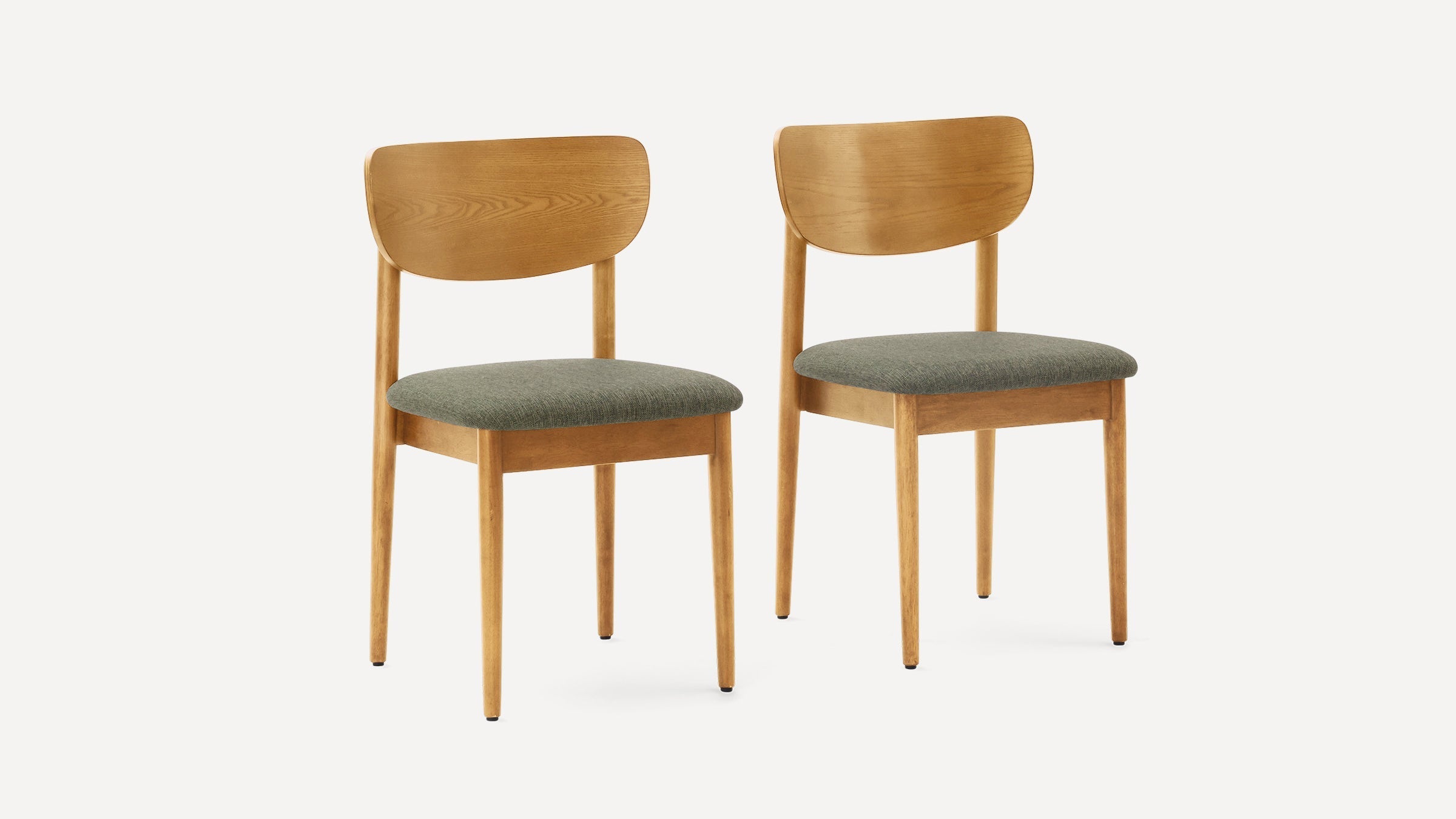 Pair of wooden dining chairs with curved backs and green upholstered seats, minimalist mid-century modern design.