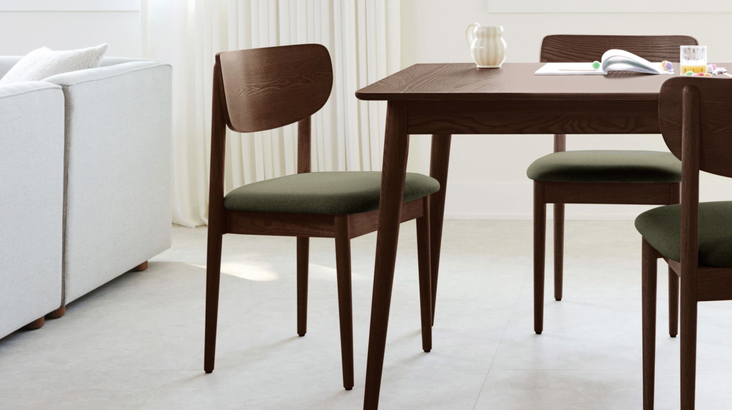 Modern dining chairs with dark wooden frames and olive green upholstered seats around a matching wooden table.