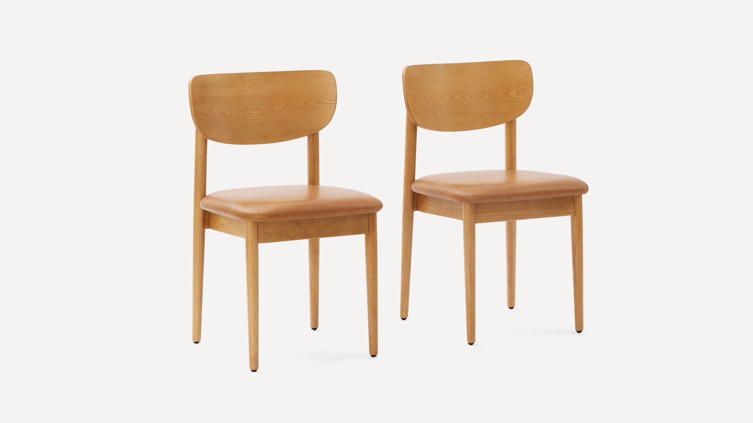 Pair of modern wooden dining chairs with light brown cushioned seats and curved wooden backrests on a white background.