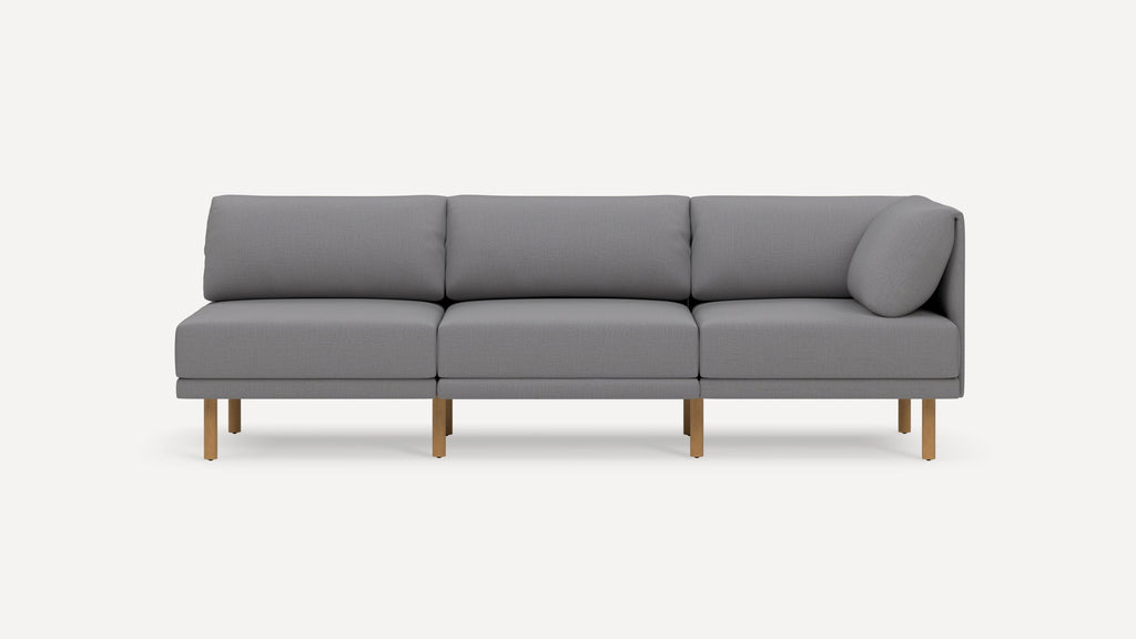 Modern gray three-seater sofa with wooden legs, cushioned seats, and backrests, featuring a sleek, minimalist design.