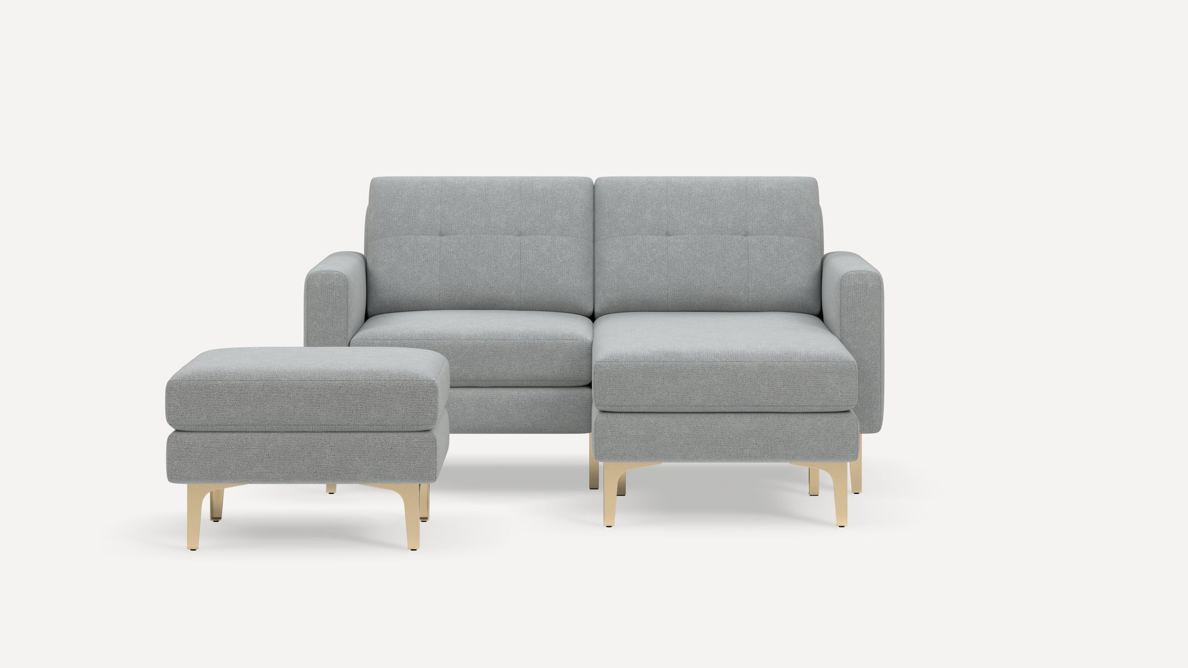 Light gray modern sectional sofa with matching ottoman, gold metal legs, and minimalist design on white background.