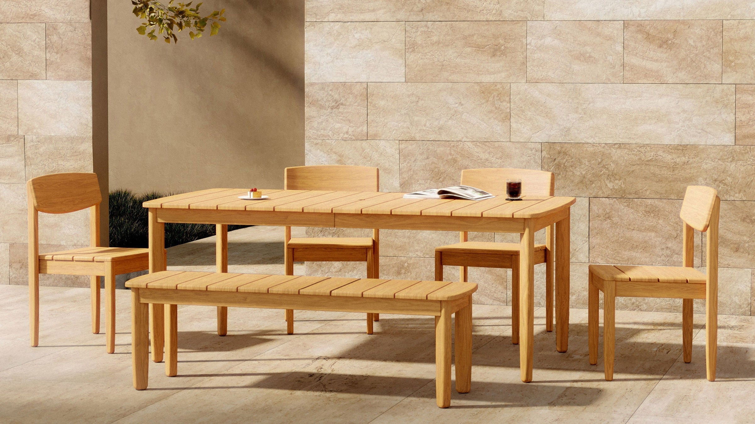 Lightwood outdoor dining set with rectangular table, three chairs, and a bench on beige stone patio against beige tiled wall.