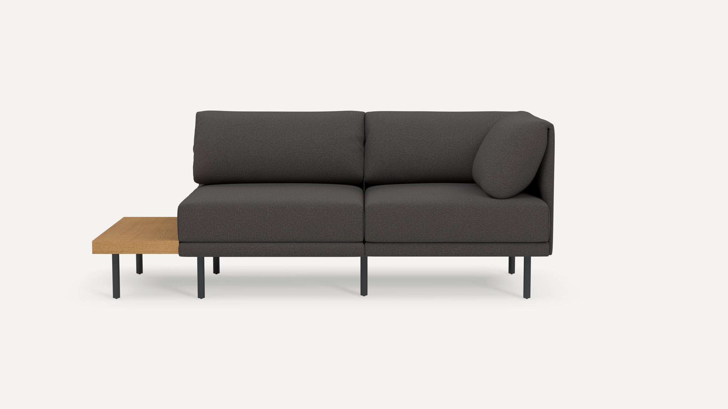 Modern dark gray sectional sofa with metal legs and an attached light wood side table on the left side.