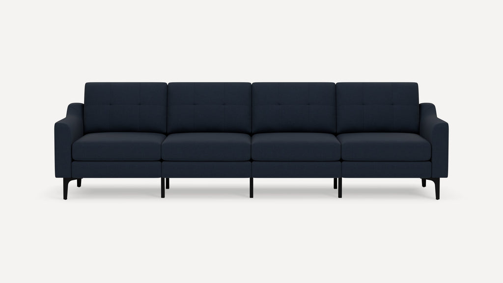 Modern navy blue four-seater sofa with tufted backrests, cushioned seats, and slim black metal legs against a white background.