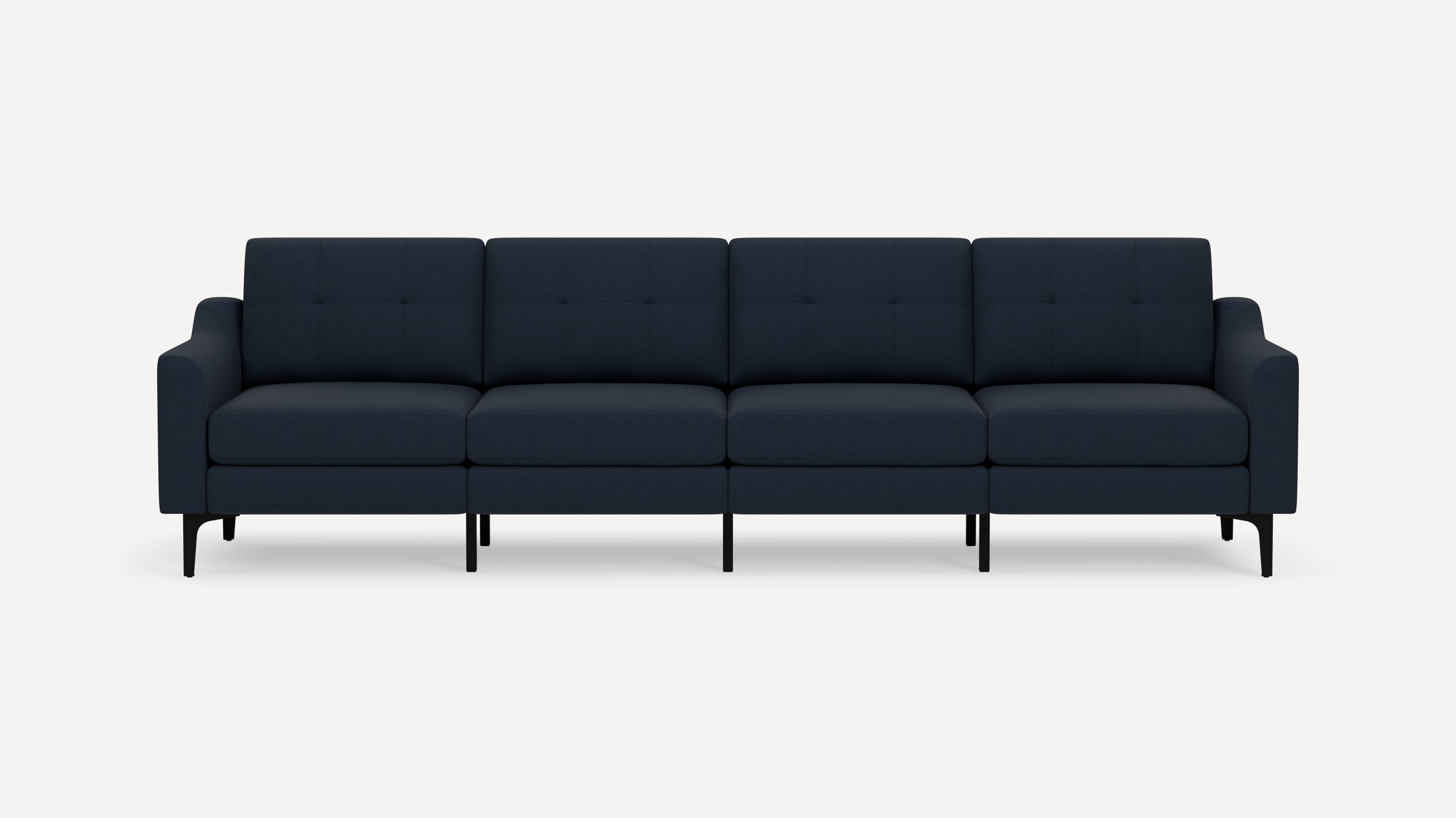 Modern navy blue four-seater sofa with tufted backrests, cushioned seats, and slim black metal legs against a white background.