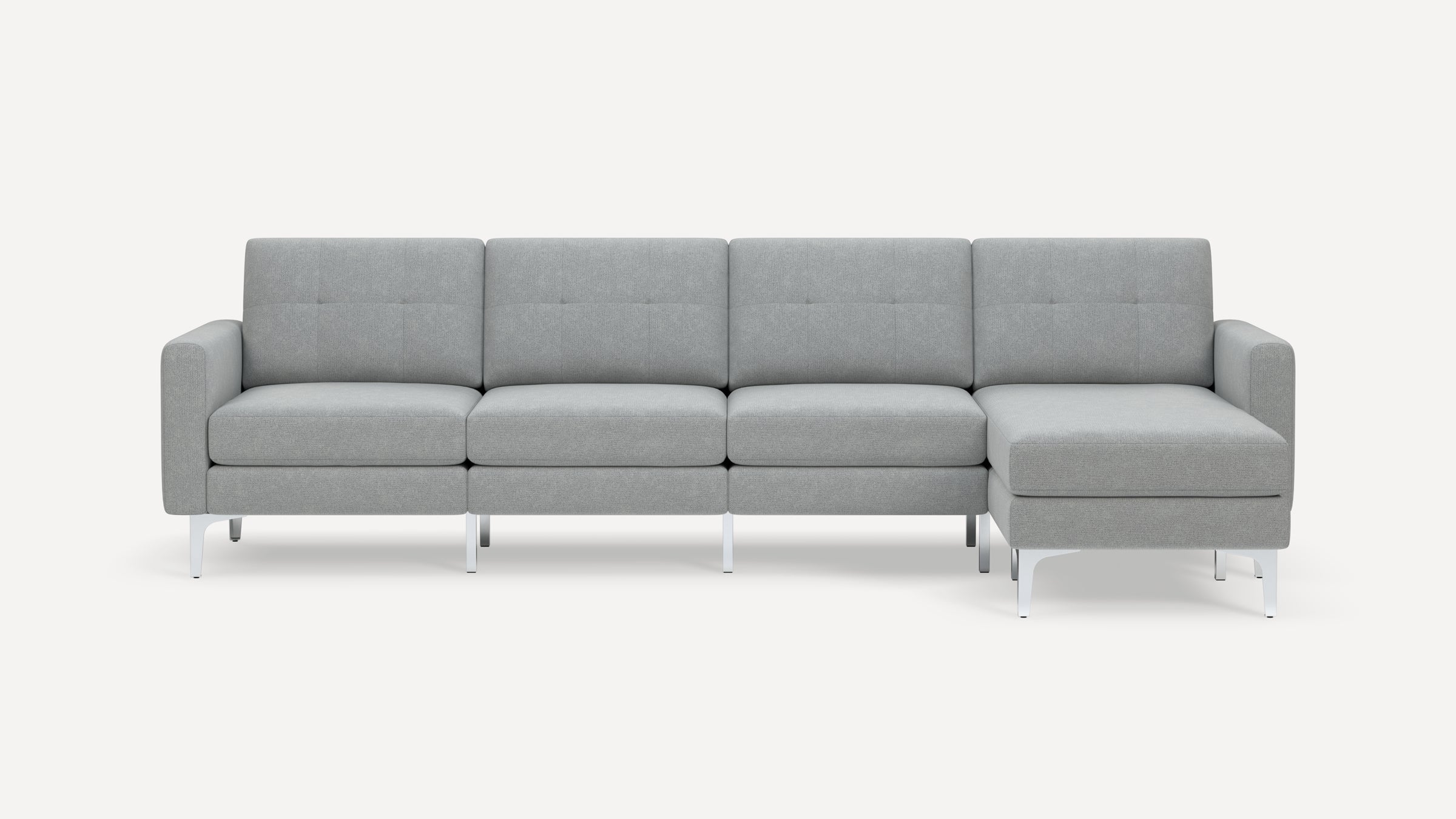 Modern light gray fabric sectional sofa with clean lines, metal legs, tufted back cushions, and chaise lounge on right side.