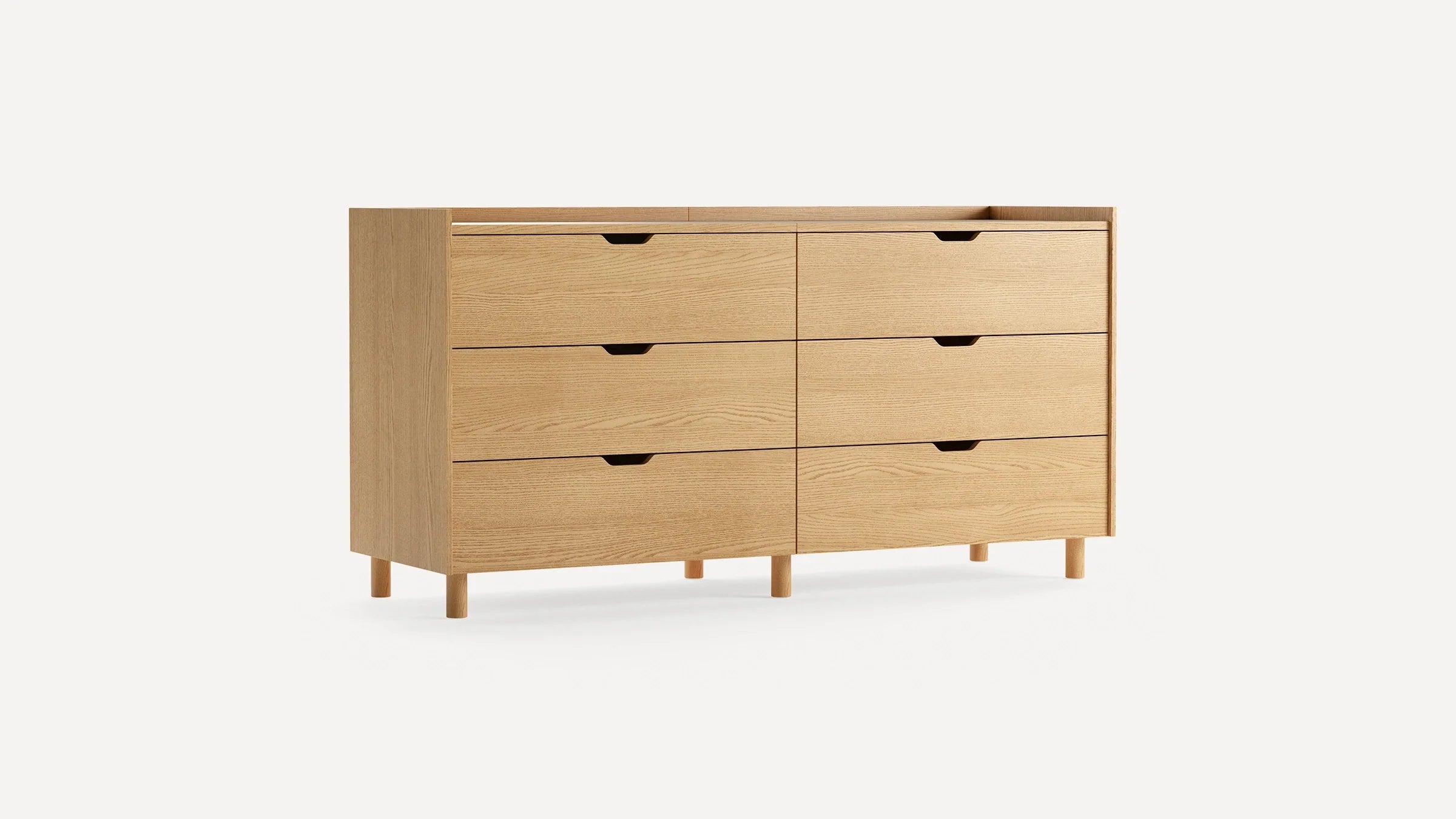 Light wood six-drawer dresser with minimalist design, recessed handles, and round wooden legs on a white background.