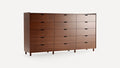 Large modern wooden dresser with sixteen spacious drawers, smooth finish, and minimalist recessed handles, standing on short cylindrical legs.