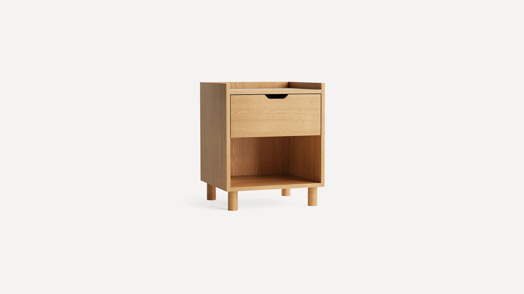 Light wood nightstand with one drawer and an open shelf at the bottom, standing on four cylindrical legs.