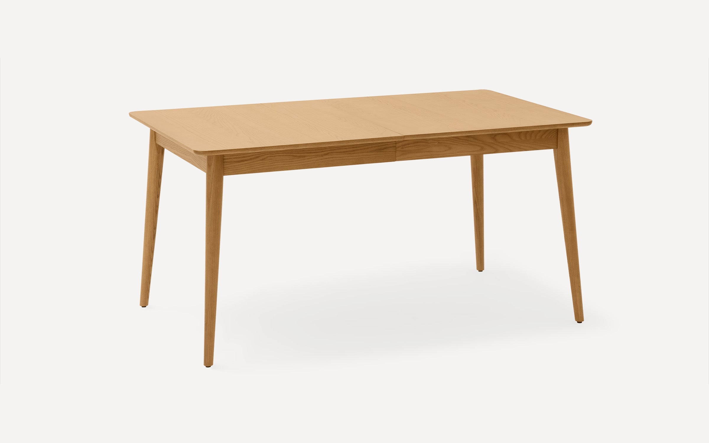 Rectangular wooden dining table with a smooth light brown finish and four tapered legs, shown against a plain white background.