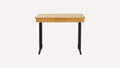 Modern wooden desk with black metal legs, featuring a flat rectangular surface and central drawer, minimalist design.