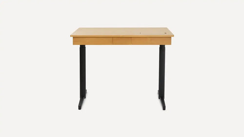 Modern wooden desk with black metal legs, featuring a flat rectangular surface and central drawer, minimalist design.