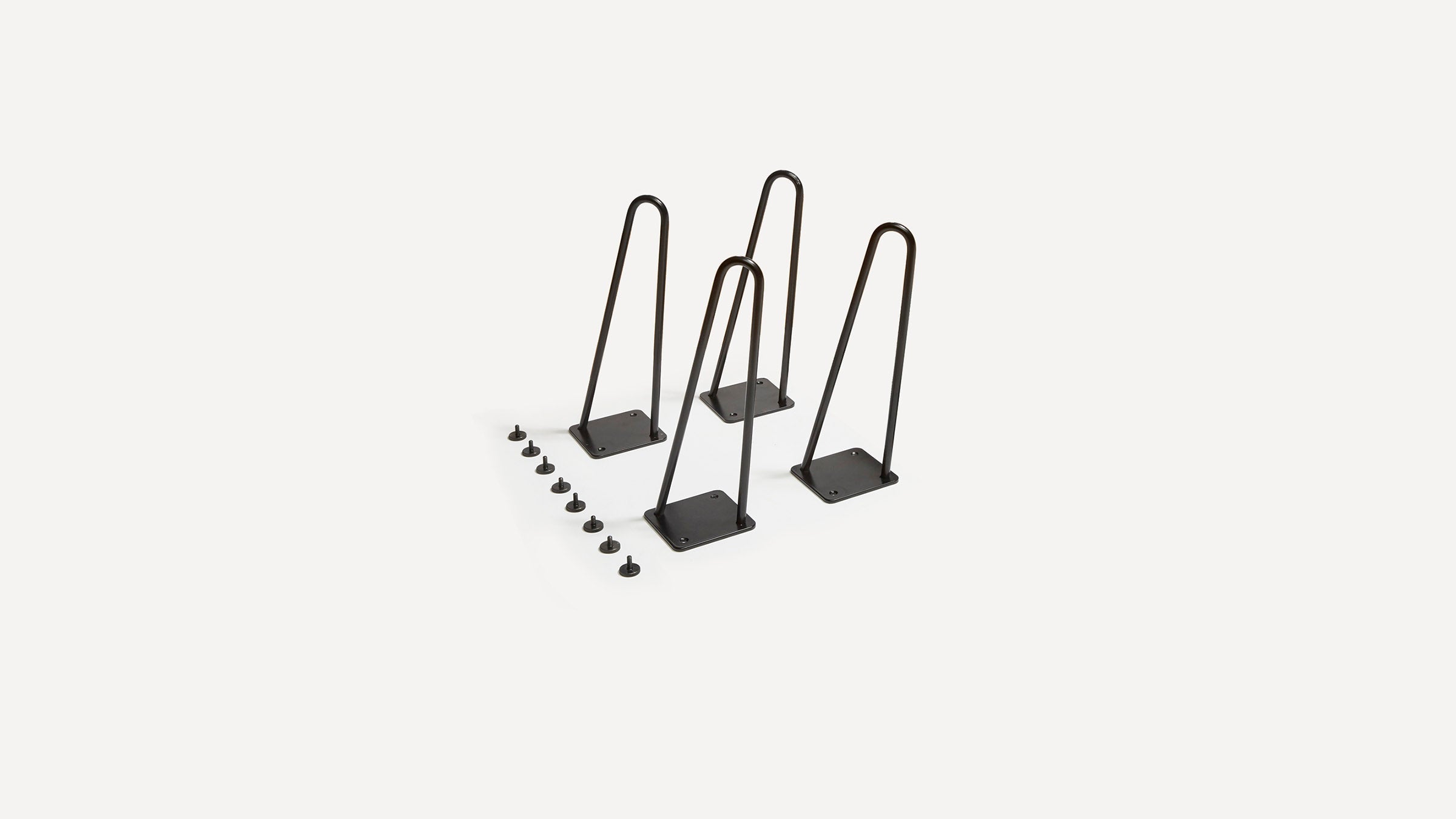 three black metal hooks on a white background
