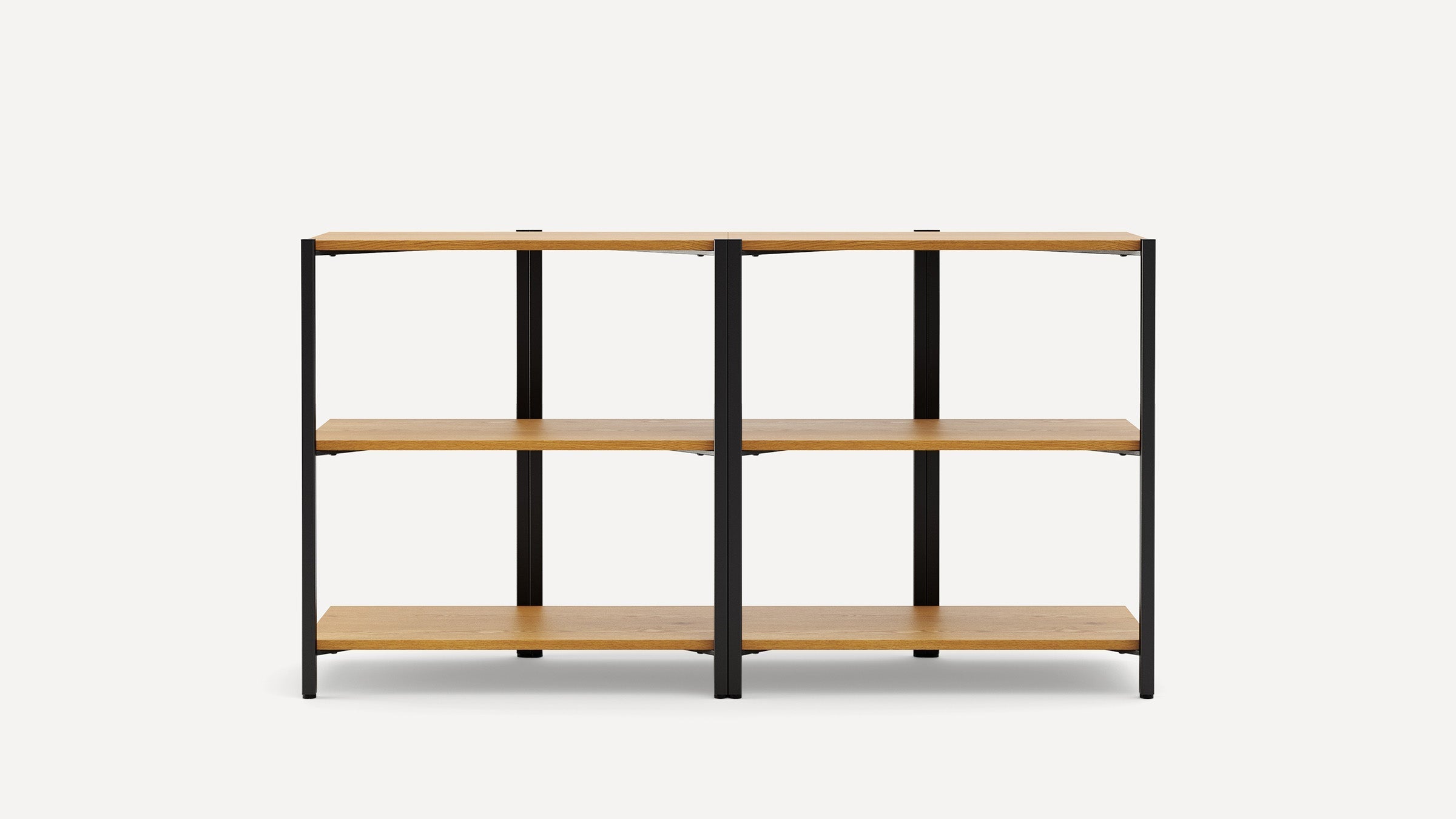 Minimalist shelving unit with three wooden shelves supported by a black metal frame, offering open storage space.