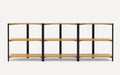 Three-section shelving unit with black metal frame and light wood shelves, modern and minimalist design.