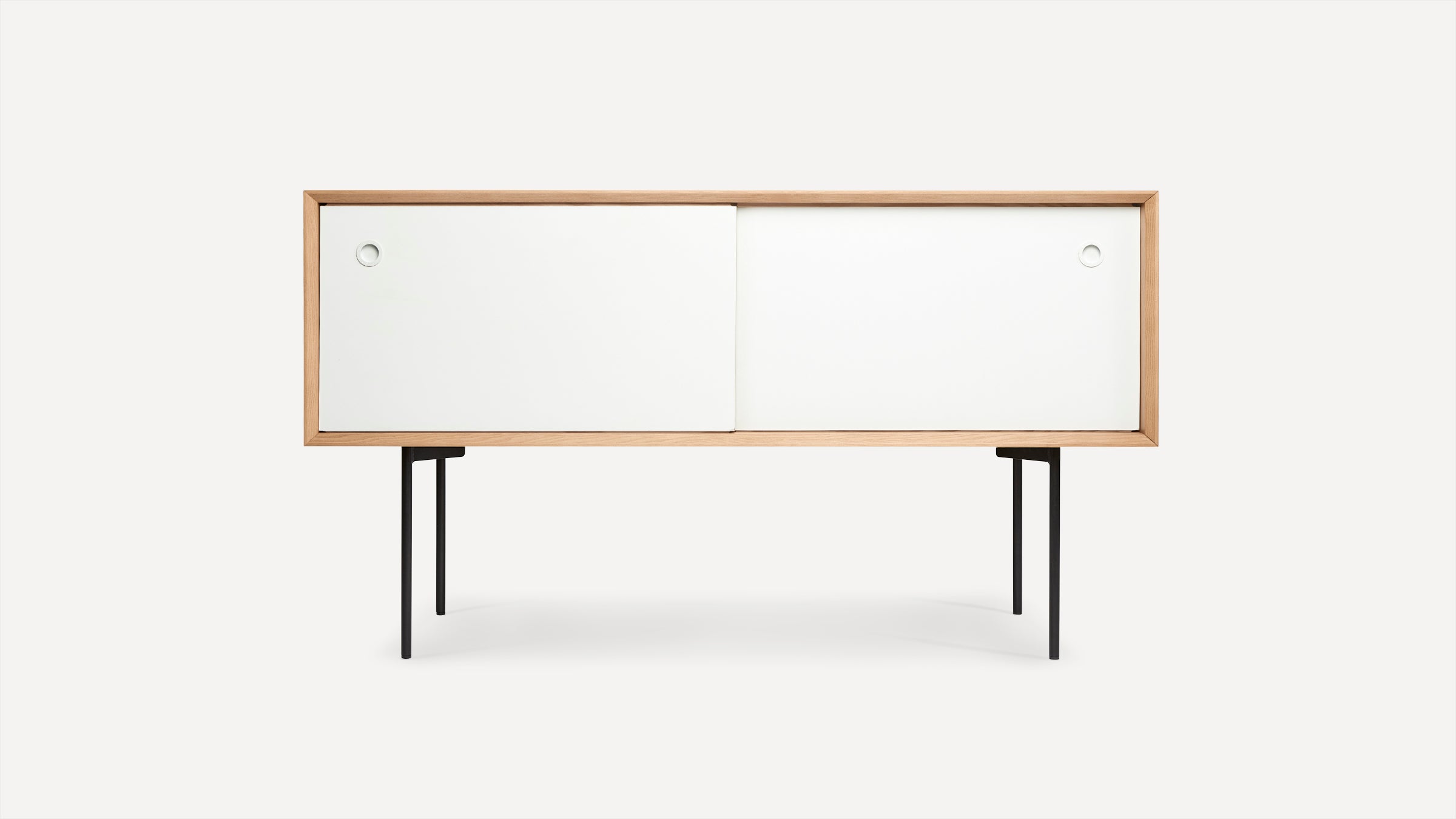 Modern wooden sideboard with two white sliding doors and slim black metal legs, minimalist design.