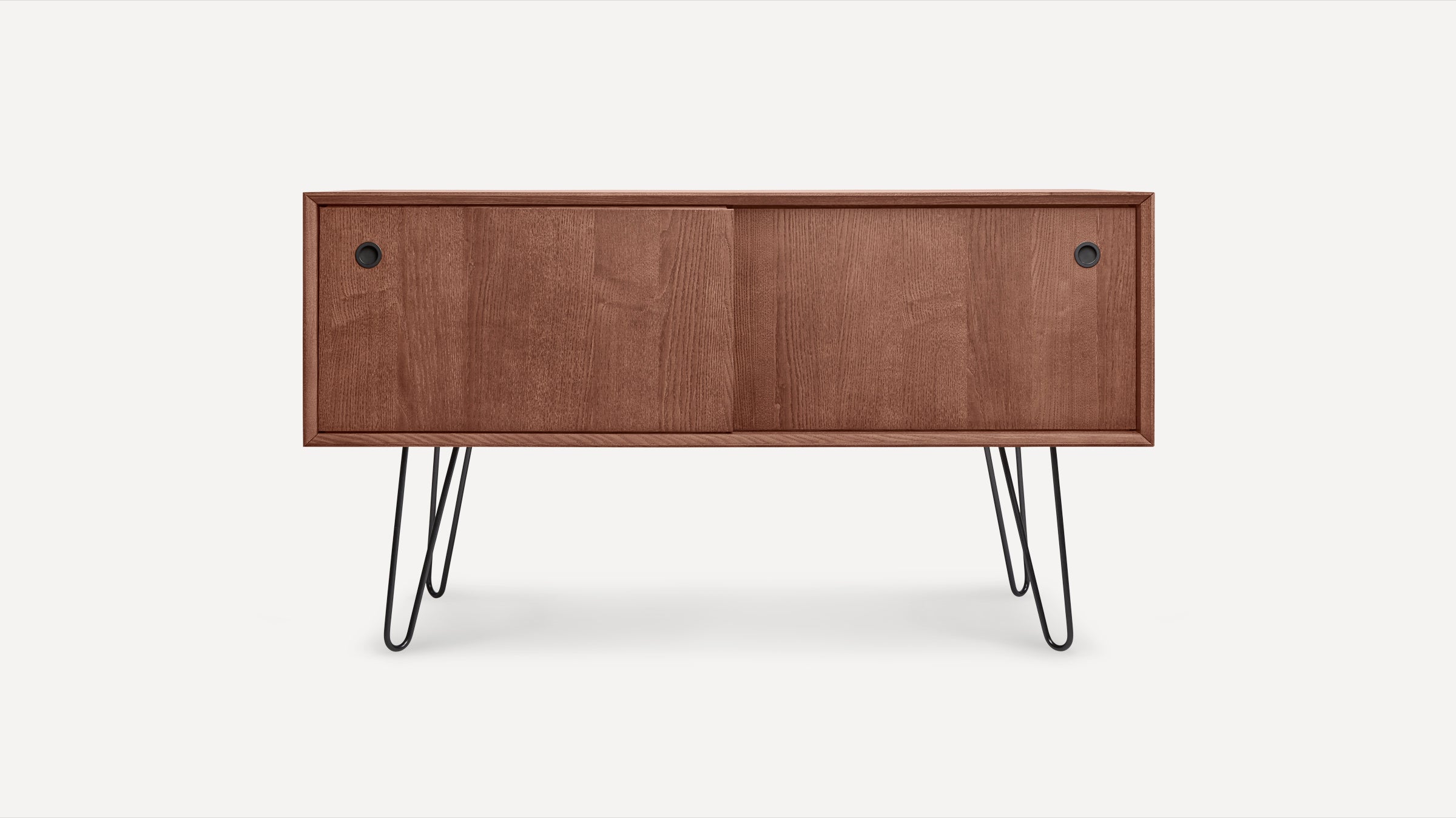 Mid-century modern wooden sideboard with sliding doors and black hairpin metal legs, showcased on plain white background.