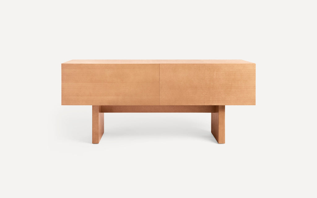 Light wood rectangular minimalist coffee table with thick legs and clean lines on a white background.