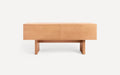 Light wood rectangular minimalist coffee table with thick legs and clean lines on a white background.