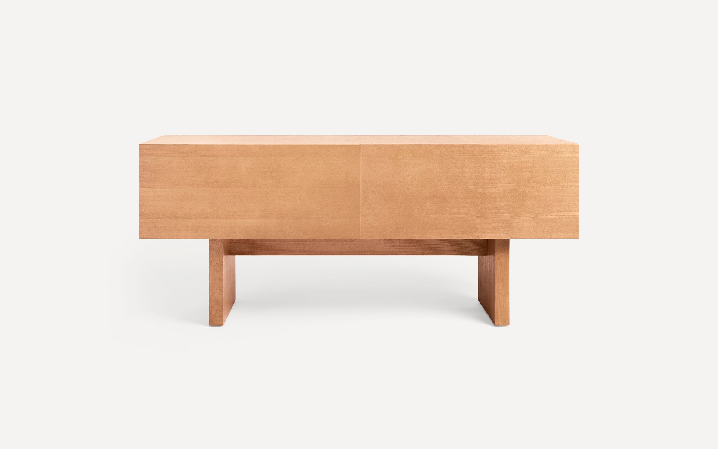 Light wood rectangular minimalist coffee table with thick legs and clean lines on a white background.