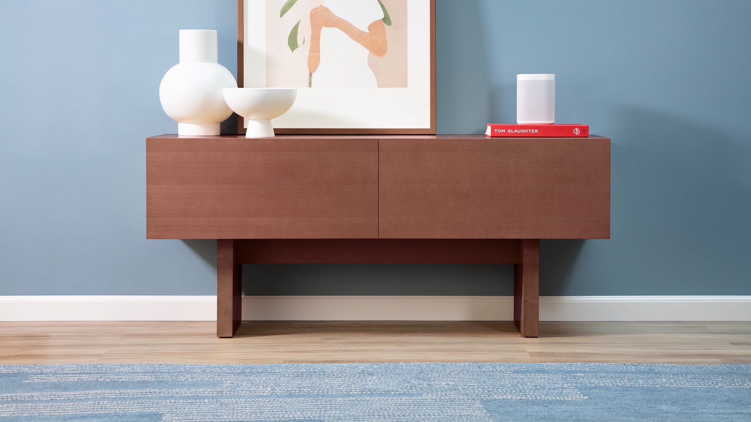 a modern sideboard with a wooden design and a blue rug