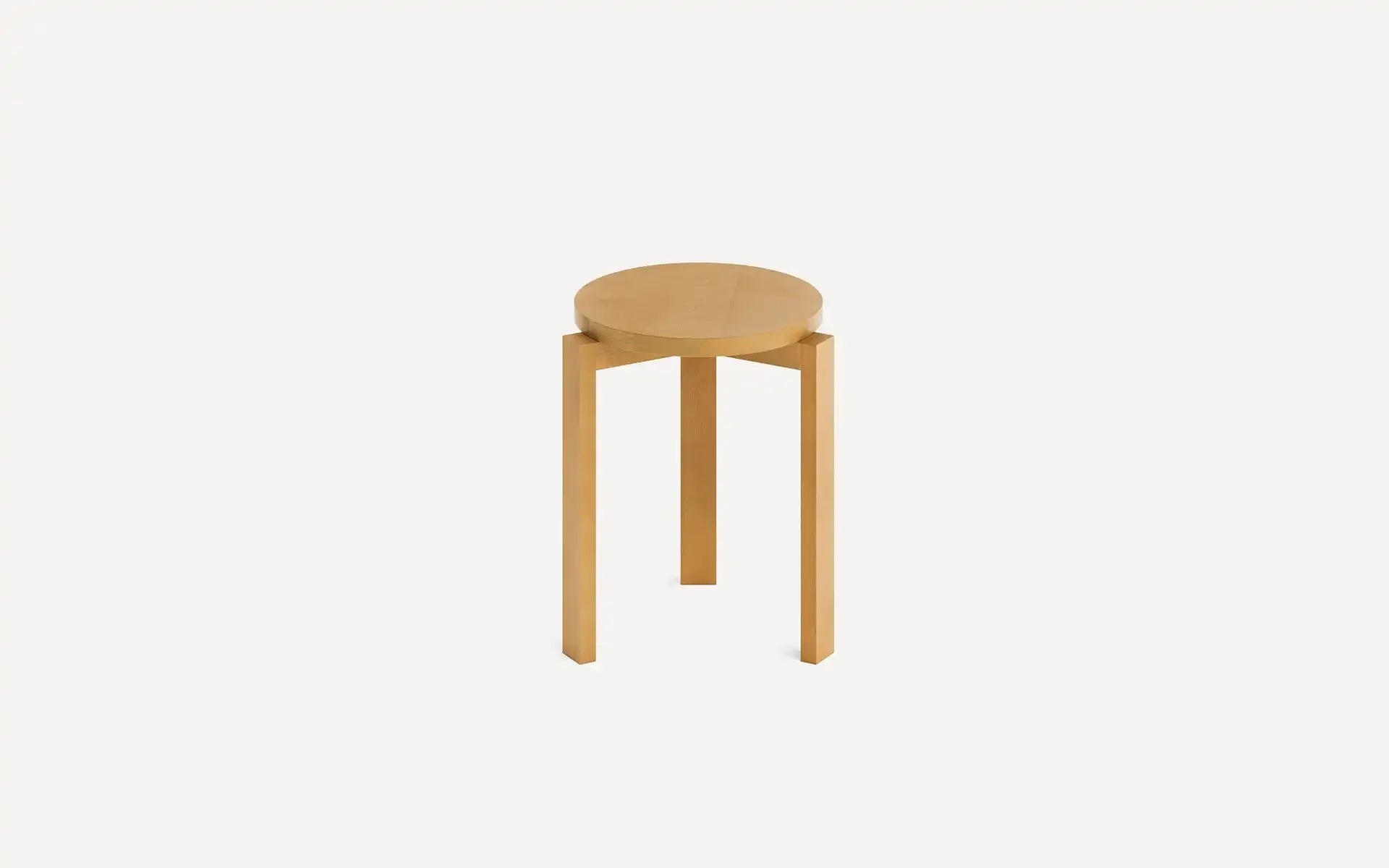 Round wooden stool with three straight legs and a light natural wood finish, set against a plain white background.