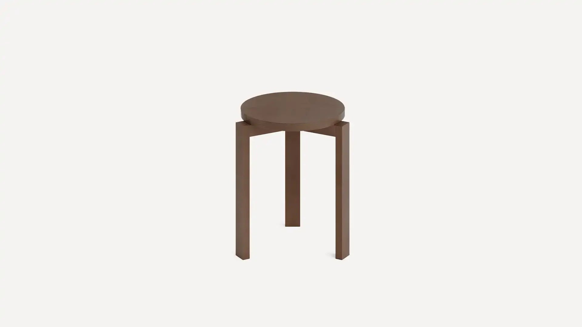 Round wooden stool with three straight legs in a minimalist design against a plain white background.