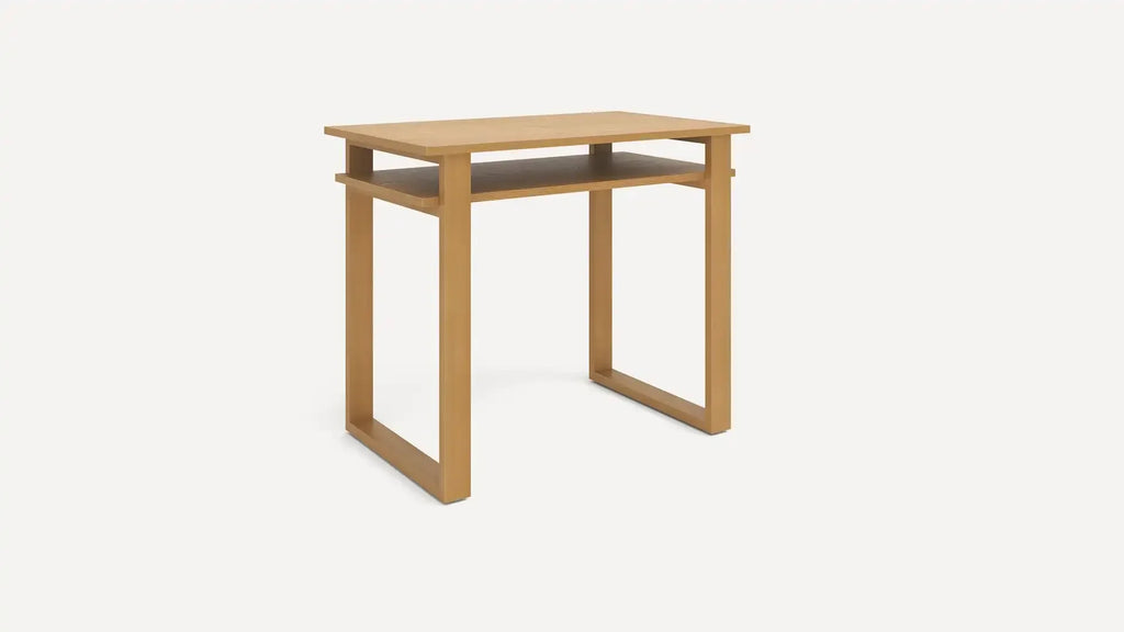 Modern light wood desk with flat top surface and an open shelf underneath, supported by geometric square legs.