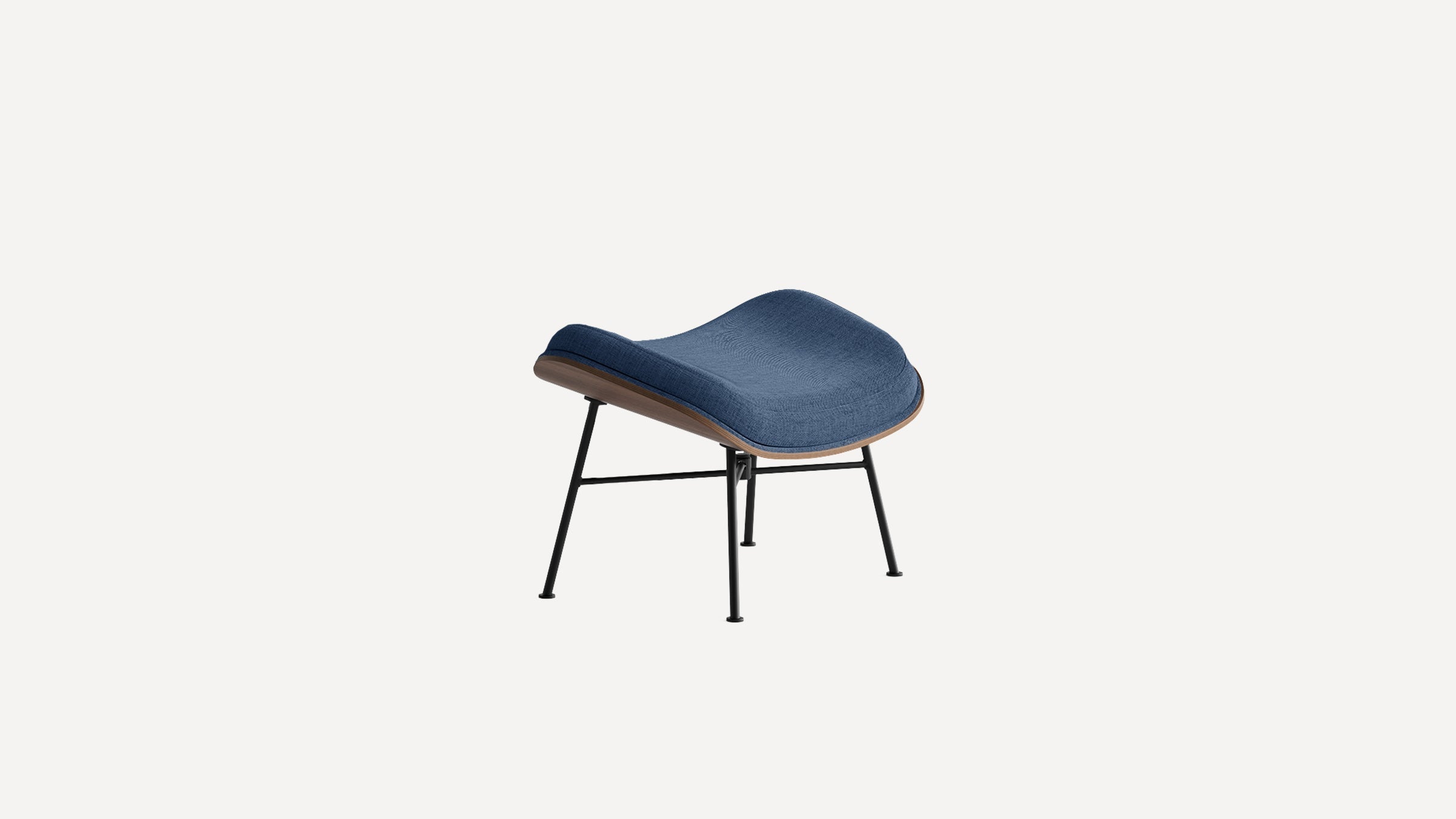 Modern ottoman with navy blue fabric cushion, curved wooden base, and black metal legs, designed for comfort and style.
